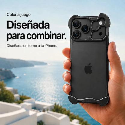Black sculpted metal phone case held in a hand above a coastal background #color_Midnight Black