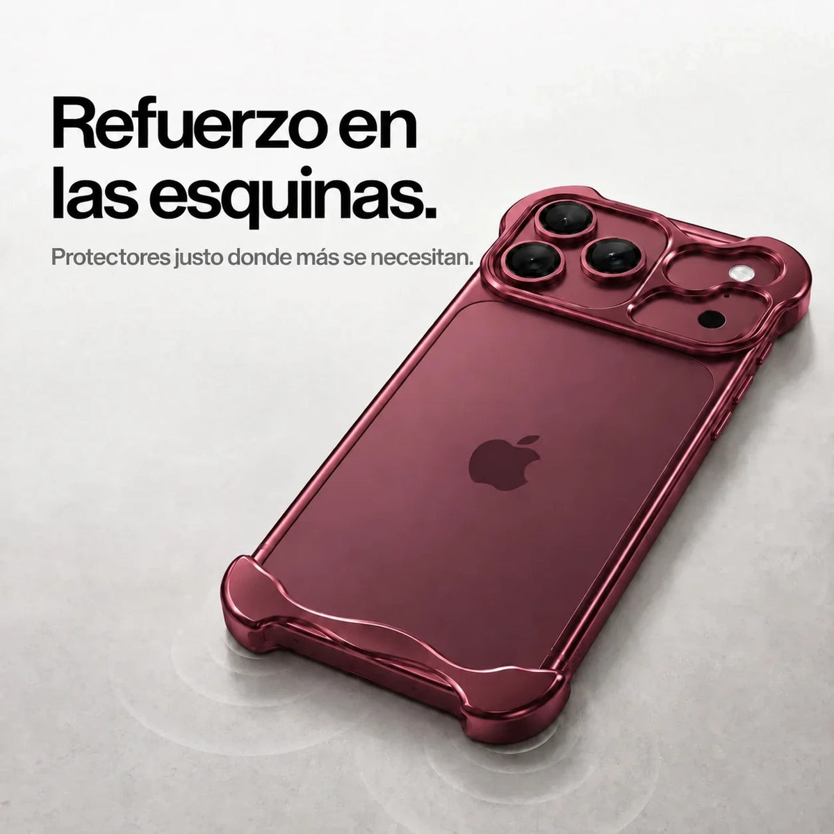 Burgundy sculpted metal phone case on a desk showing its corner bumpers #color_Burgundy
