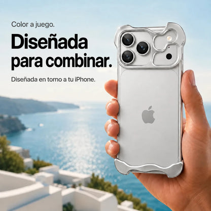 Silver sculpted metal phone case held in a hand above a coastal background #color_Titanium Silver